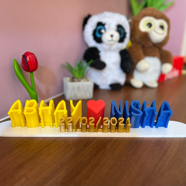 A personalised 3D printed name plank in yellow, red and blue